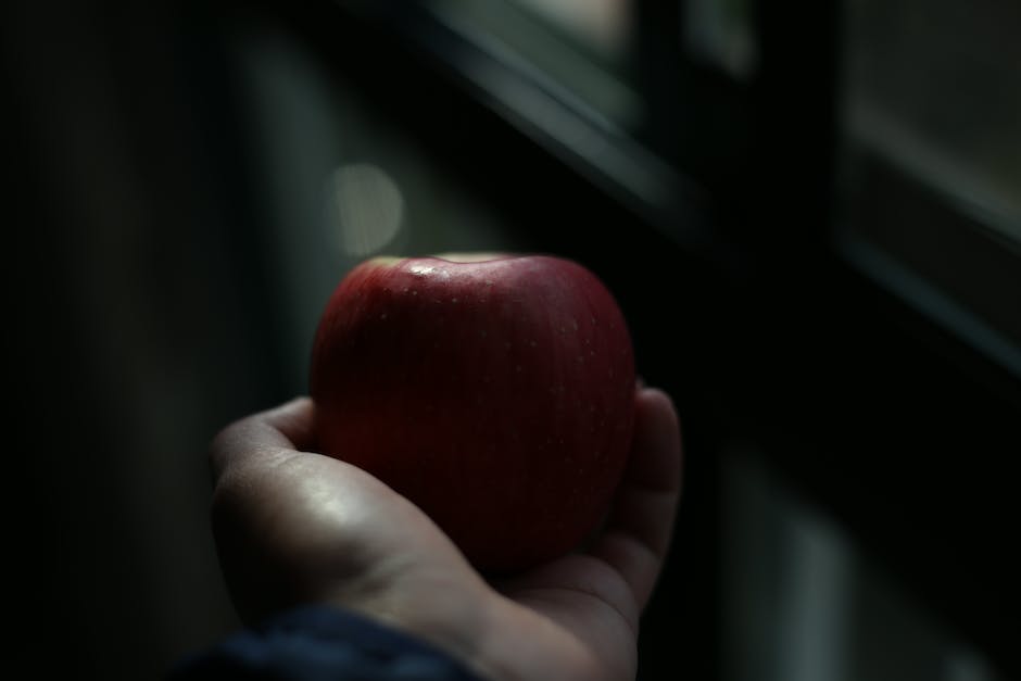 An image depicting a person holding an apple in a dream-like setting.