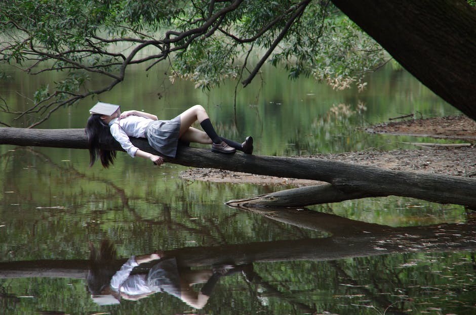 An image depicting a person sleeping and surrounded by various dream-related symbols.